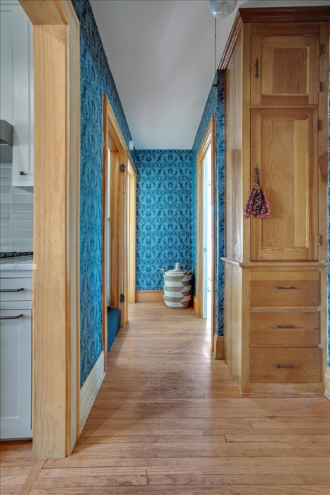 Blue knot wallpaper in hallway with global basket