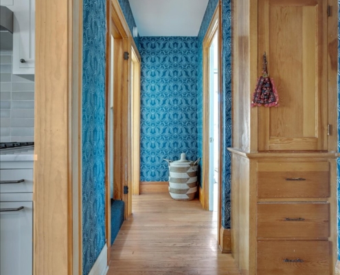 Blue knot wallpaper in hallway with global basket