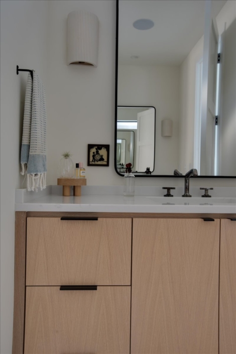 Bathroom vanity, mirror, towel, and accessories