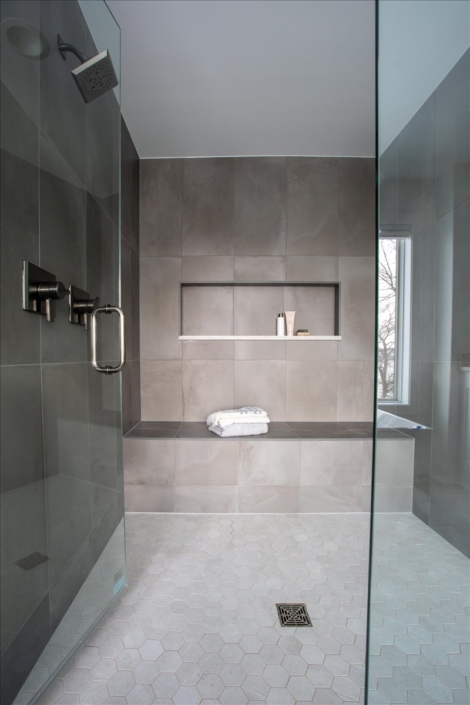 Large double shower with bench in gray tile