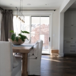 Wood farmhouse table paired with Restoration Hardware chairs