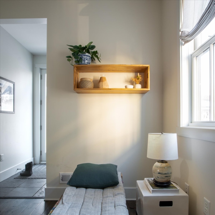 Back entry bench with floating shelf and small lamp