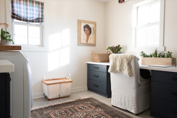 Laundry room with desk area and art