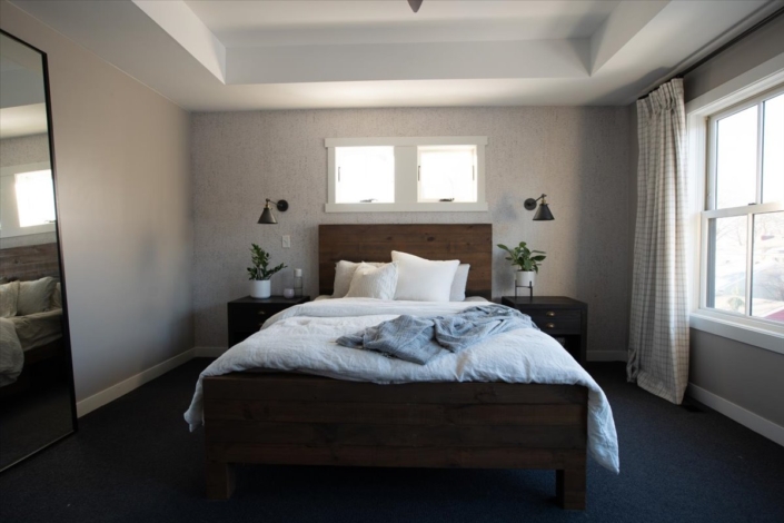 Master bedroom bed with night stands and sconces