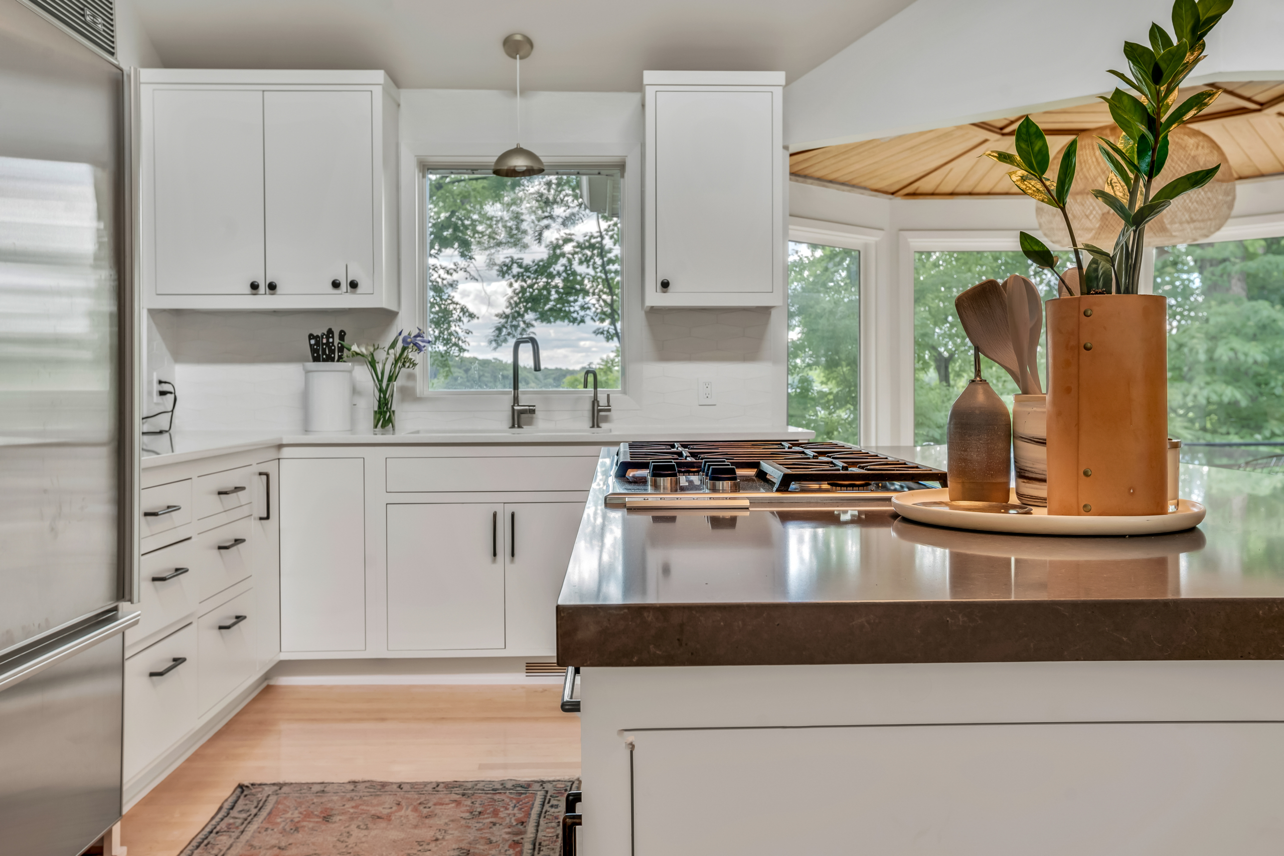 kitchen looking towards sink with an island and a rug runner